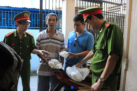 Cán bộ C49 (Bộ Công an) bắt quả tang Võ Văn Thanh (bên trái) vừa mua chất cấm salbutamol (tạo nạc, tăng trọng) từ Công ty TNHH thủy sản E-Birds tại Q.Bình Thạnh, TP.HCM.